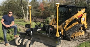 Mitchell Makowski posing with his Milton CAT excavator on the job site. 